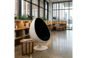 The Replica Ovalia Egg Chair by Henrik Thor-Larsen functioning as a sleek, acoustic dampening sensory pod in a modern library.