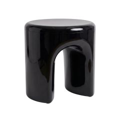 An angled perspective of the black Replica Tooth Stool, brilliantly highlighting the distinct arch and 11 cm gap between the two softly curved legs.
