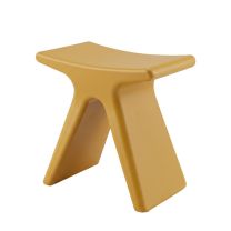 An angled perspective of the plastic Mustard Butterfly Stool, clearly highlighting the sweeping, curved silhouette inspired by butterfly wings and the vibrant yellow finish.