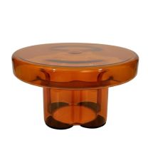 An angled view of the Napier Retro Glass Coffee Table in amber, showing the transparency of the glass and the curved profile of the base.