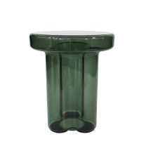 A slight angled view of the green Napier Retro Glass Side Table, highlighting the transparency and the smooth curve of the glass leg.