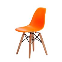 An angled front perspective of the vibrant orange Replica Charles Eames Kids Chair, highlighting the highly practical, easy-to-clean plastic shell and the sturdy beech timber legs.