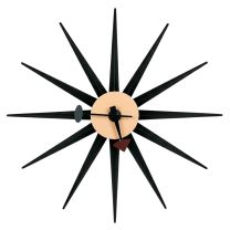 Front-on view of the mid-century inspired Replica George Nelson Starburst Clock, featuring sleek black wooden rays radiating from a clean, minimalist steel clock face.