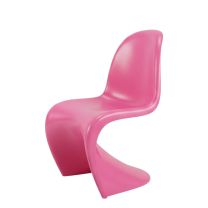An angled perspective of the vibrant pink Replica S Chair, beautifully highlighting its fluid, gravity-defying 1960s cantilever design.