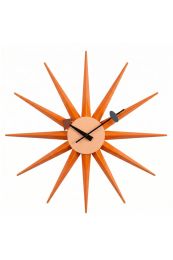 Front-on view of the mid-century inspired Replica Starburst Clock, featuring vibrant sunburnt orange wooden rays radiating from a clean, minimalist clock face.