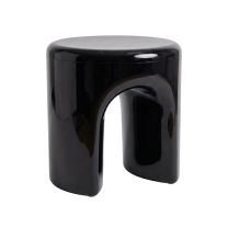 An angled perspective of the black Replica Tooth Stool, brilliantly highlighting the distinct arch and 11 cm gap between the two softly curved legs.