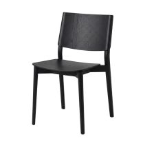 An angled perspective of the matte black Viking Dining Chair, highlighting the continuous sweeping back legs and the gently contoured, ergonomic plywood seat.