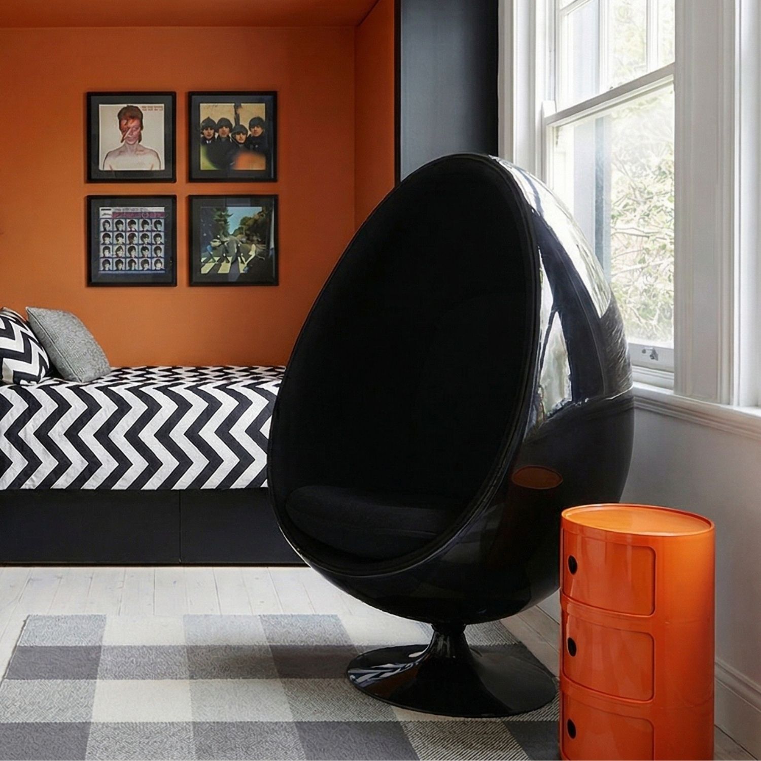 Orange Replica Componibili styled in a retro teen bedroom next to an Ovalia chair.