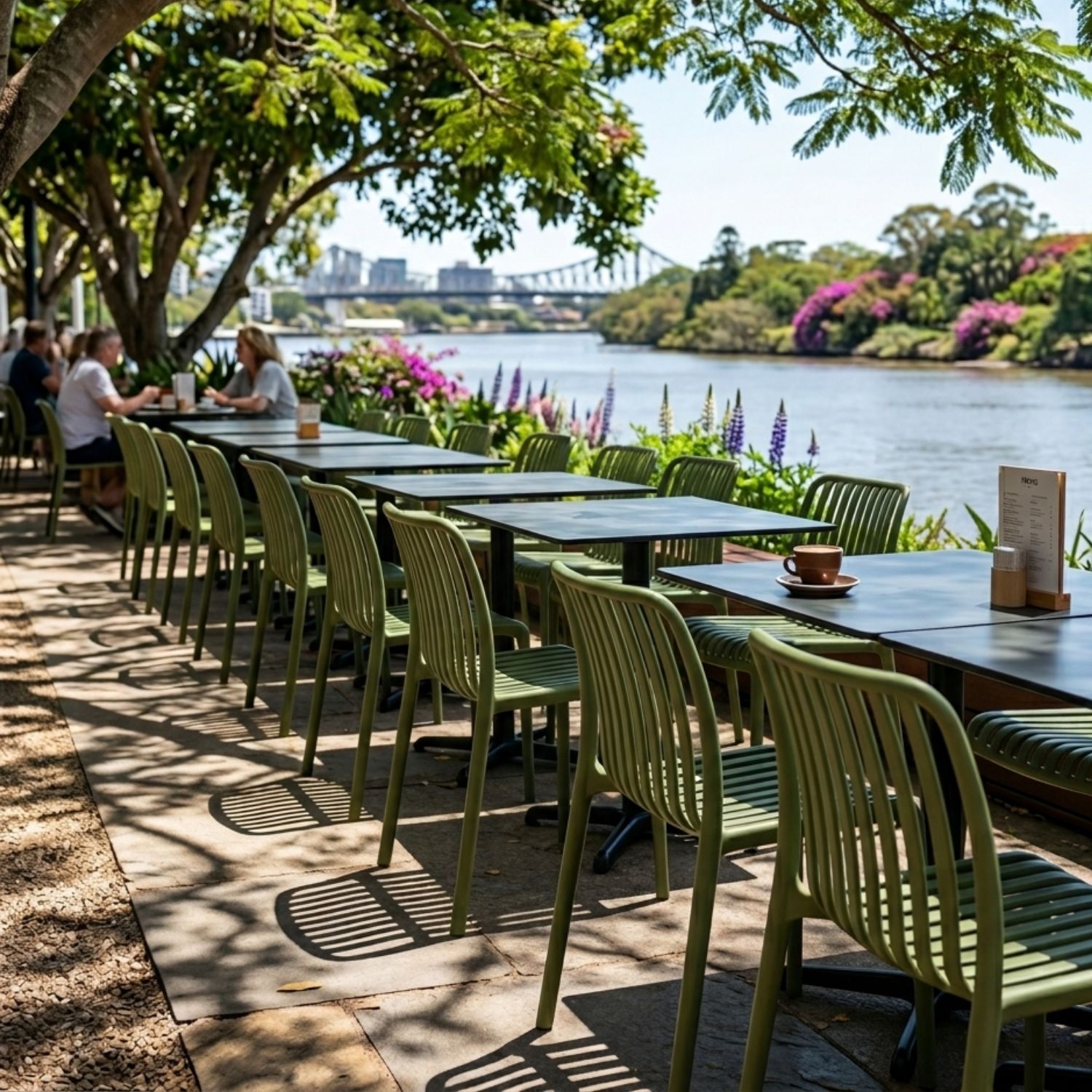 A commercial outdoor dining space featuring the Bordeaux Stacking Polypropylene Outdoor Dining Chair in Olive.