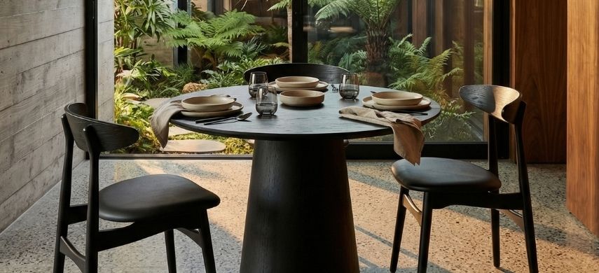 A beautifully styled dining room featuring the sculptural mid-century Replica Moon Table