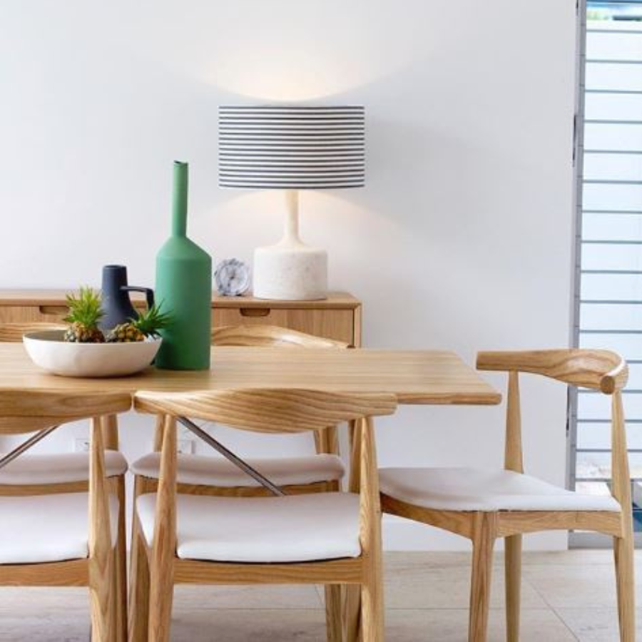Styled Home with Solid Ash Timber Dining Chairs with Curved Backrest and White Soft Pad Seat around a Timber Dining Table
