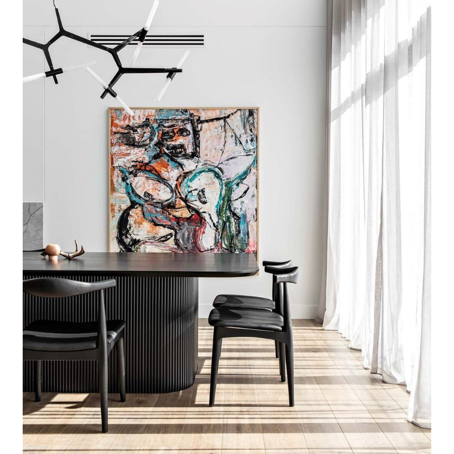 Styled photo of the Replica Hans Wegner Elbow Chairs CH20 Black Frame & Black Seat Pad Styled Black Timber Frame Dining Chair with Curved Back Rest and Upholstered Black Padded Seat