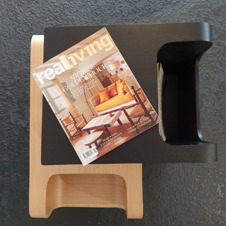 Versatile plywood side table in both black and natural displayed with a magazine