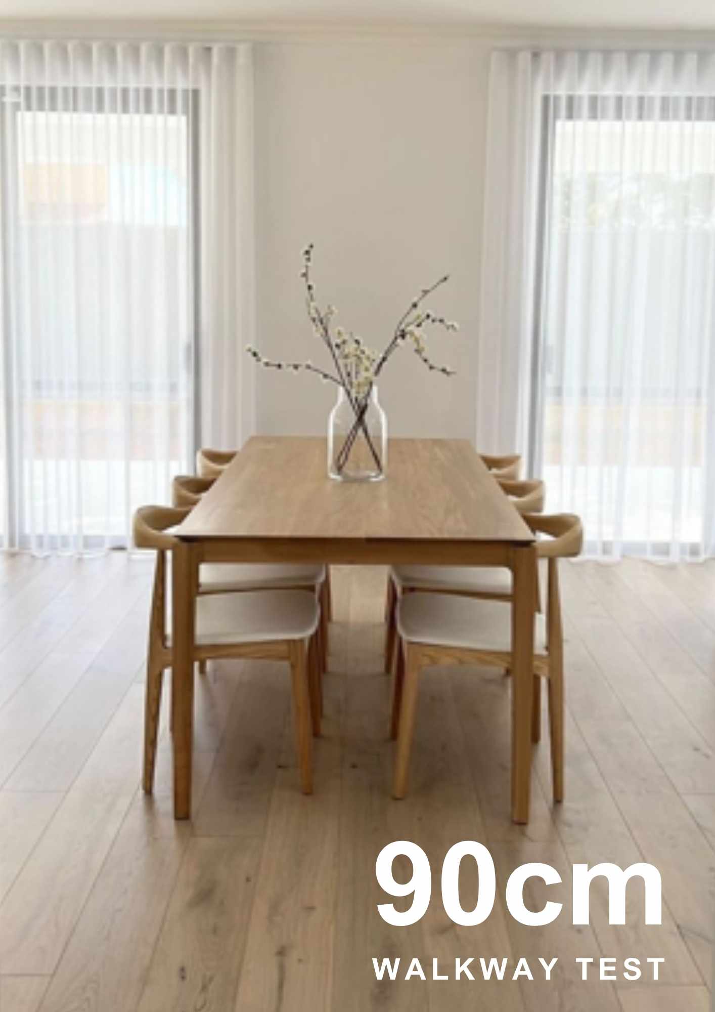 Ensure Ample Walkway Space for Comfortable Dining. Modern minimalist dining room with dark table and chairs, demonstrating ample walkway space around the setting.