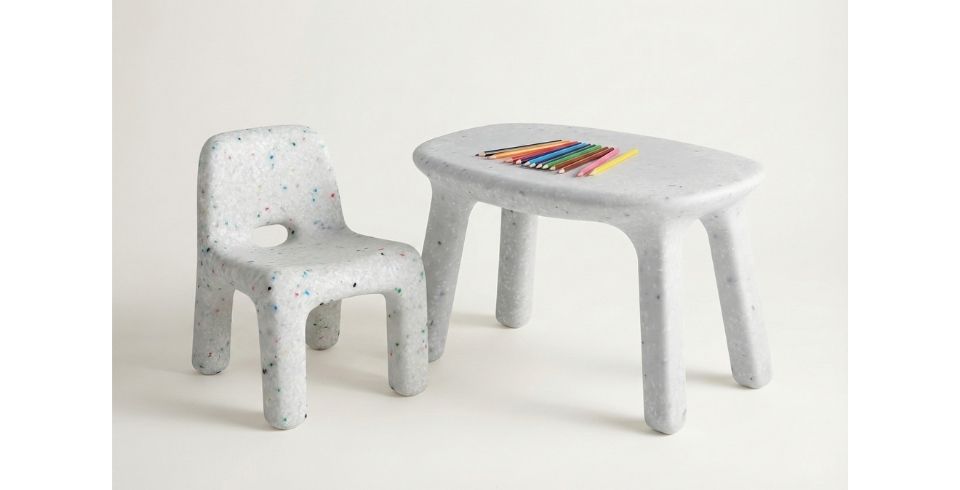 Shop the Recycled Plastic Kids Confetti Range. Kids Confetti Table and Chair set made from white recycled plastic with colorful speckles, styled with colored pencils for a modern playroom.