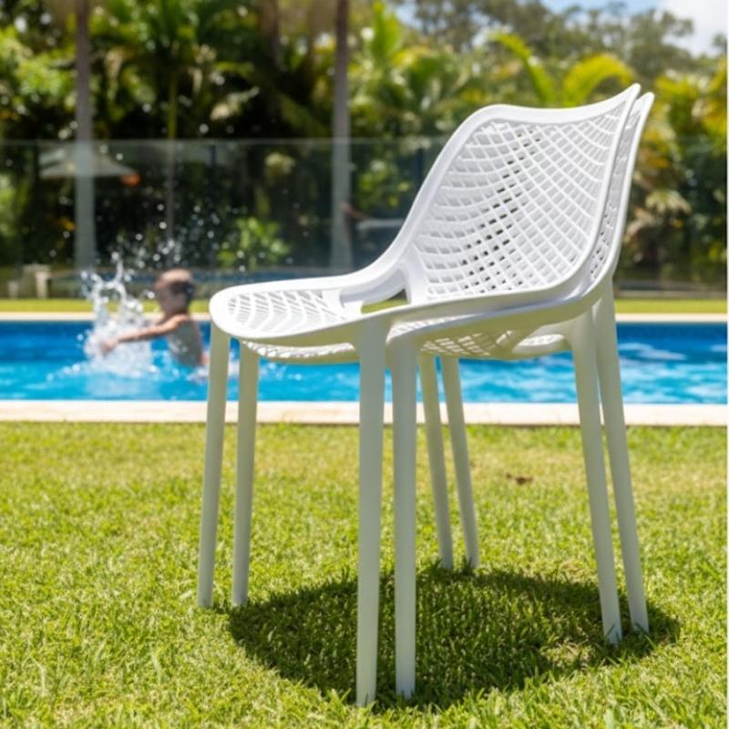 Stack of Ozone outdoor chairs showing space-saving design.