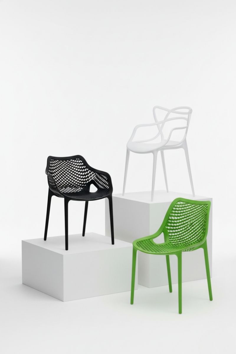 Explore the wide variety of modern designer plastic outdoor chairs. Studio image showcasing distinct designer plastic outdoor chairs (Replica Net, Replica Masters styles) in black, white, and green, emphasizing color variety and design