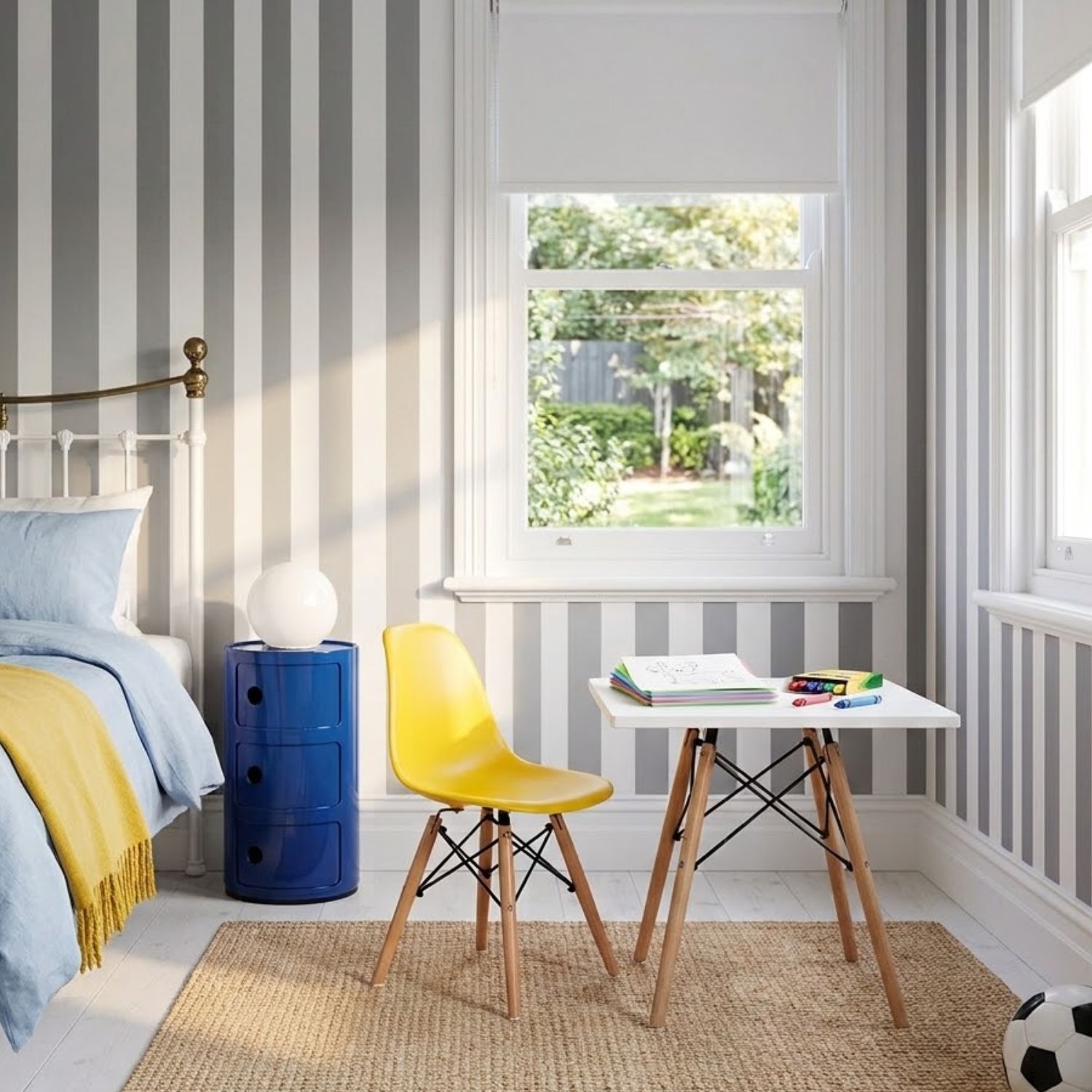 Yellow Replica Charles Eames Kids Chair and Blue Componibili Bedside Table Yellow Replica Charles Eames kids chair and a blue Replica Componibili storage unit used as a bedside table in a modern boy's bedroom.
